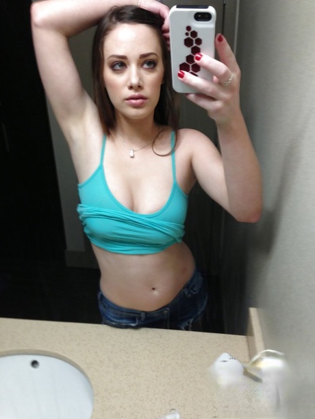 Hot amateur pictures herself as she strips down and teases her pussy