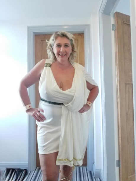 Blonde mature with huge melons Camilla C shows her bum in a solo