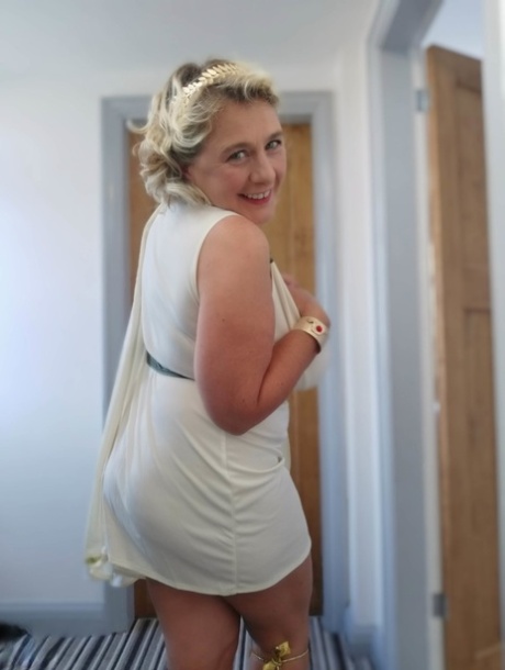 Blonde mature with huge melons Camilla C shows her bum in a solo