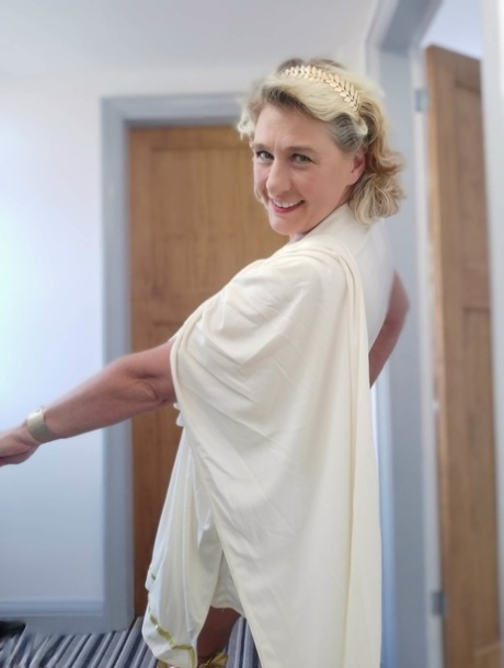 Blonde mature with huge melons Camilla C shows her bum in a solo