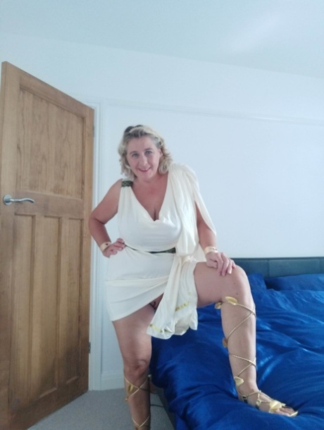 Blonde mature with huge melons Camilla C shows her bum in a solo