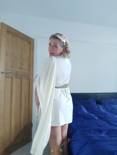 Blonde mature with huge melons Camilla C shows her bum in a solo