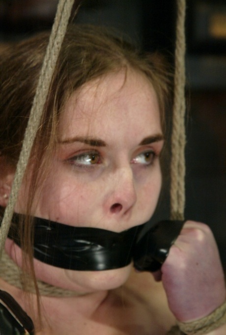 Restrained and gagged female is flogged and masturbated against her will