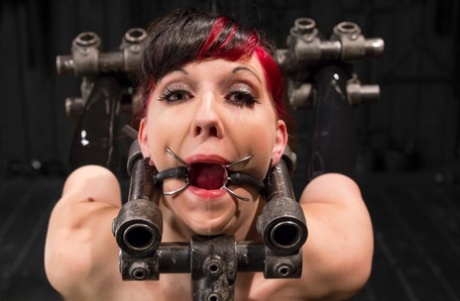 White lady Nerine Mechanique is immobilized before a machine fucks her mouth