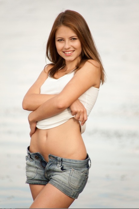 Alluring babe Hilary C shows off her naked petite body at the beach
