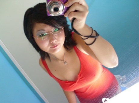 Amateur Asian girl with big tits takes sexy selfies in the mirror