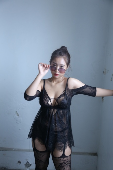 Kinky Asian honey poses completely nude and teases with her big tits and ass