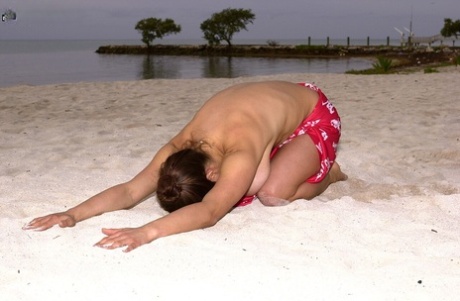 Horny brunette mom Chloe Vevrier lets out her big tits & hairy twat on a beach