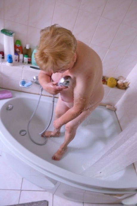 Granny Oma Geil washes her saggy tits and mature holes before getting dressed